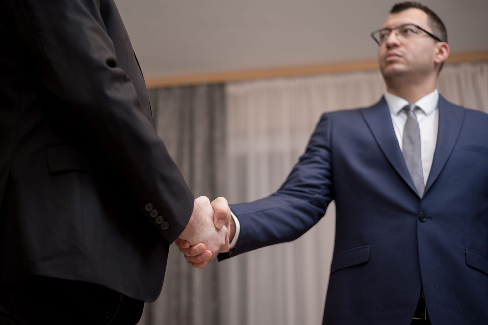 Business handshake representing aligned interests in commercial debt recovery